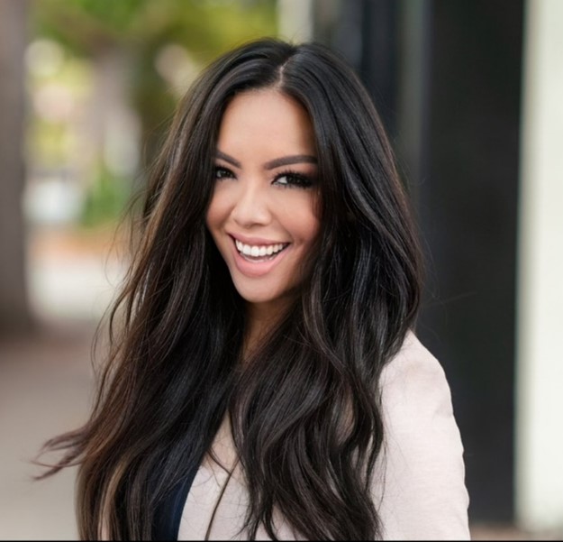 woman with long dark hair wearing a white blazer