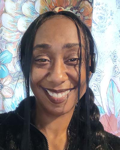 Carol Rashawnna Williams in front of her artwork