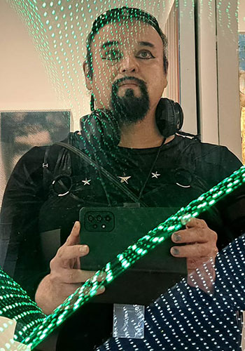 Xavier takes a photo of himself in a mirror that has an overlay of green lines on it.