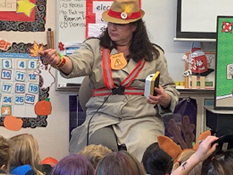 Woman presenting an educational program to young students