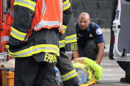 Firefighter/EMTs packaging a patient for transport