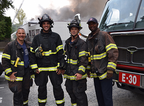 Engine 30 firefighters standing in front of their apparatus