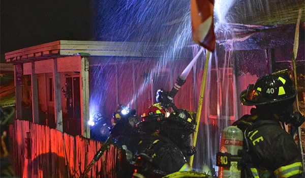 Firefighters putting water on a fire.