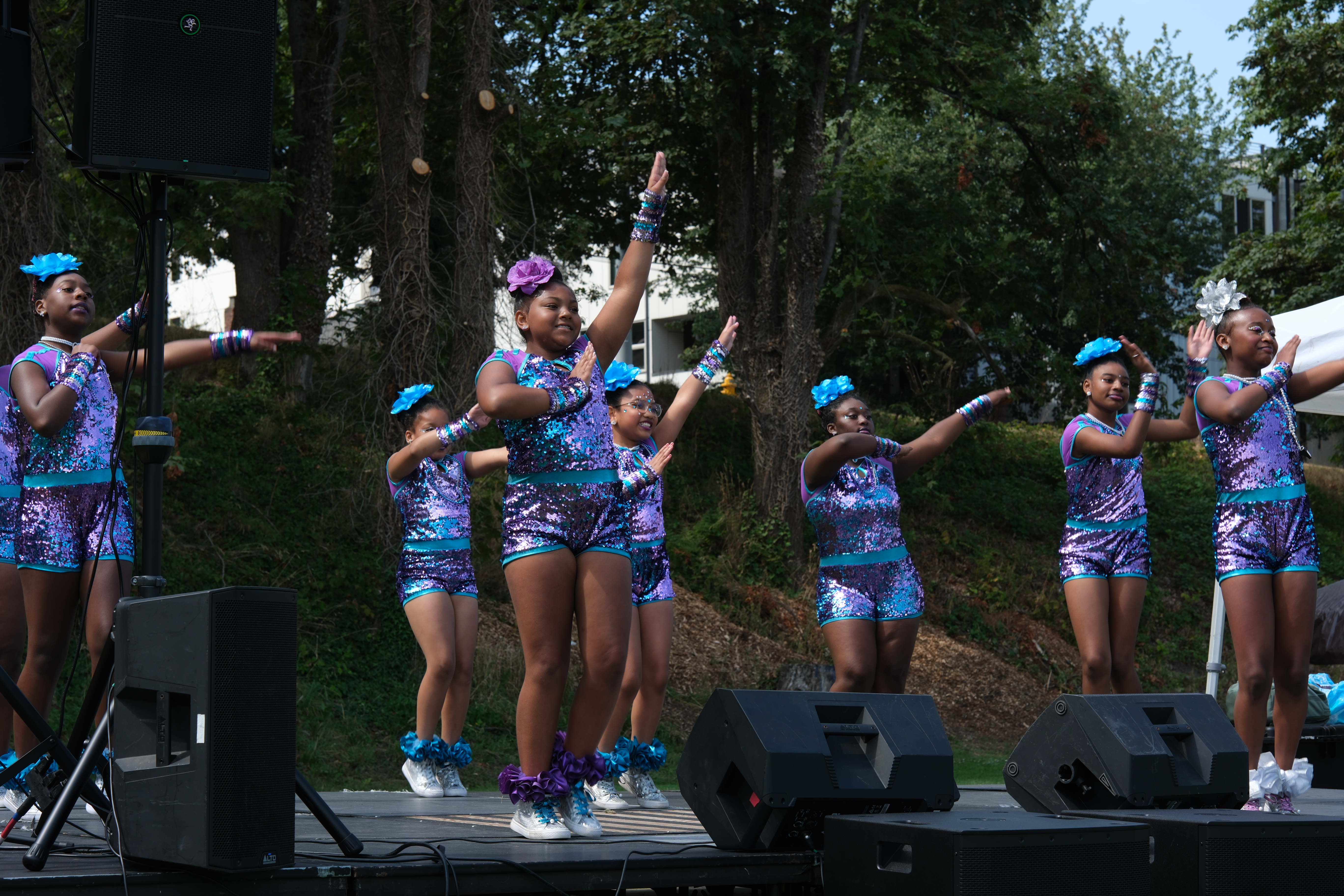A dance team of young girls, performing in matching outfits