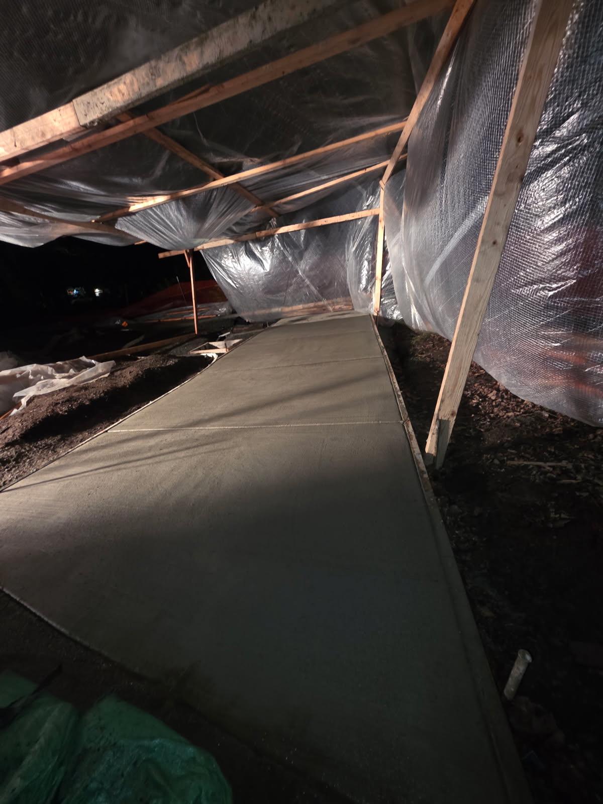 The paving job curing overnight under protective covering