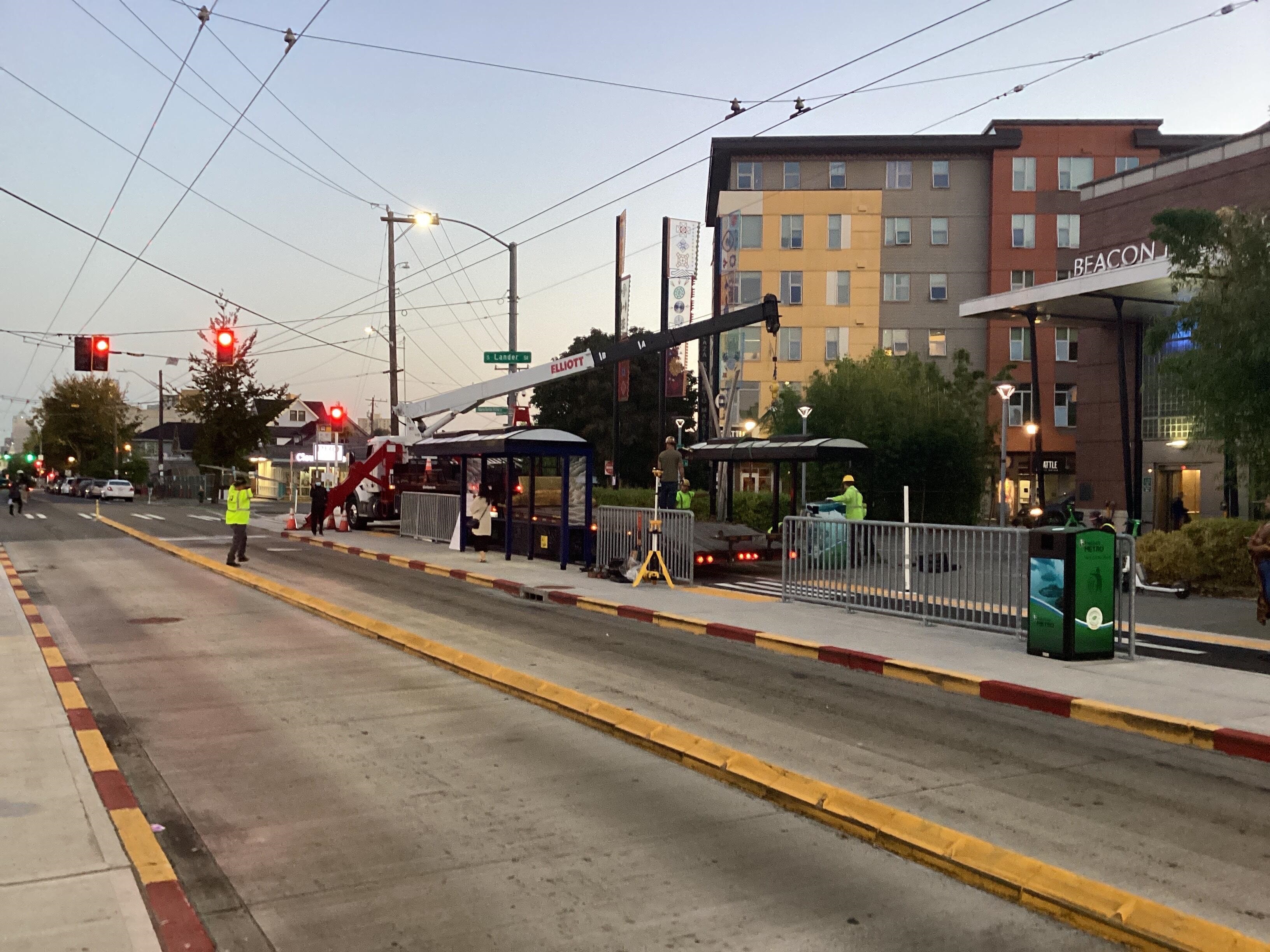 Crews installing the bus shelter outside of Beacon Hill Station.