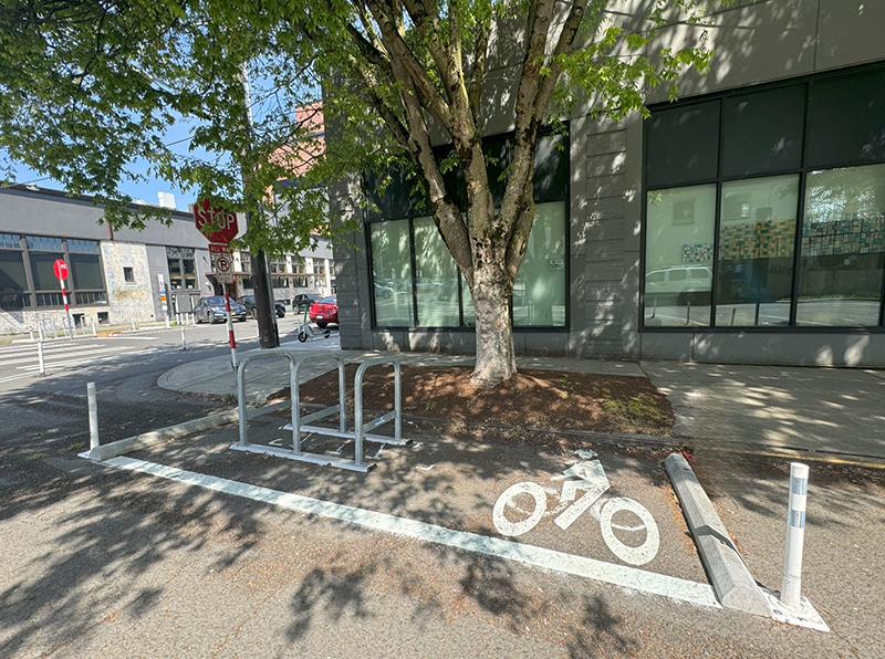 On Street bike parking with a rack and an area for bikes to be stacked.