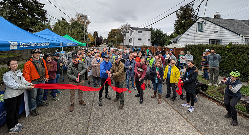Director Spotts and neighbors cut the ribbon on the 6th Ave NW Greenway