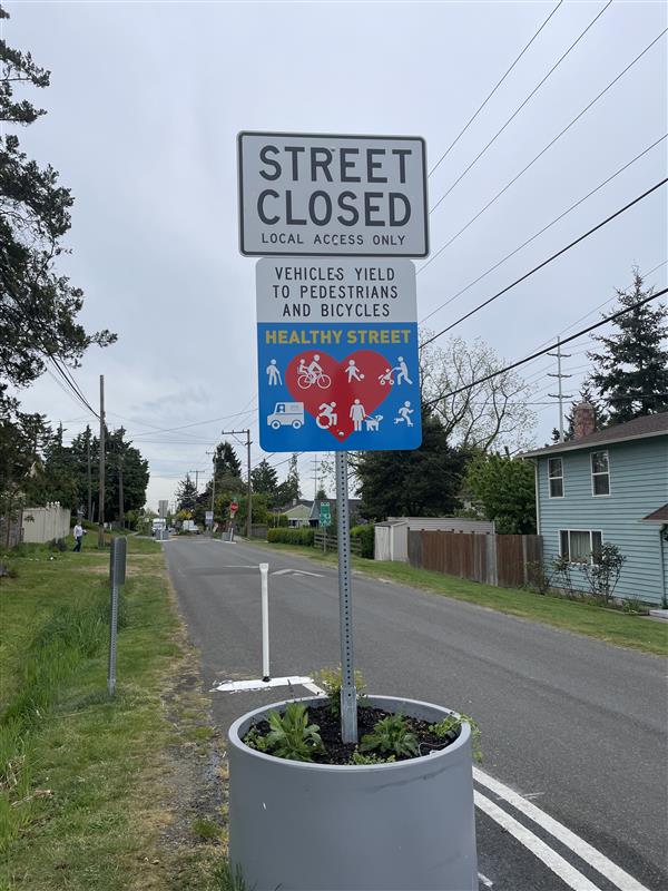 Healthy Street sign and planter with plants inside 