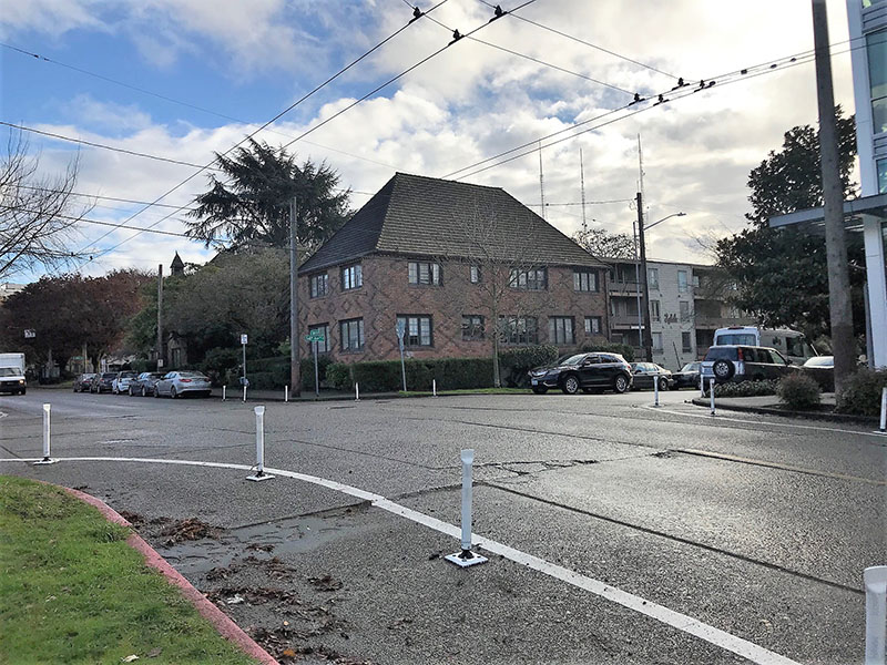 Painted curb bulbs with white plastic posts at 14th Ave and E and E John Street.