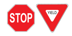 A red stop sign and a red yield sign