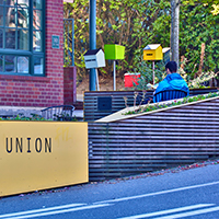 A person enjoying outside seating in a neighborhood parklet.