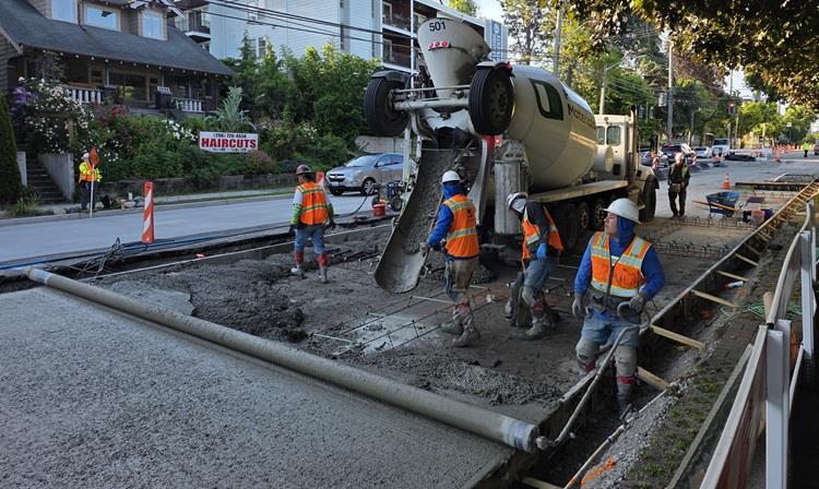 Image shows the team pouring concrete along Eastlake Ave E near E Roanoke St
