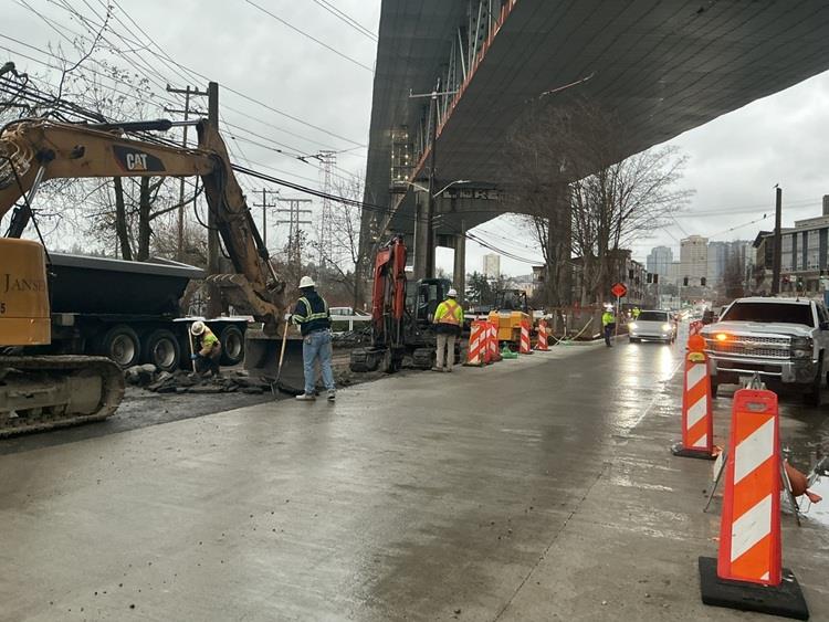 Image shows new concrete street panels being poured just south of the University Bridge