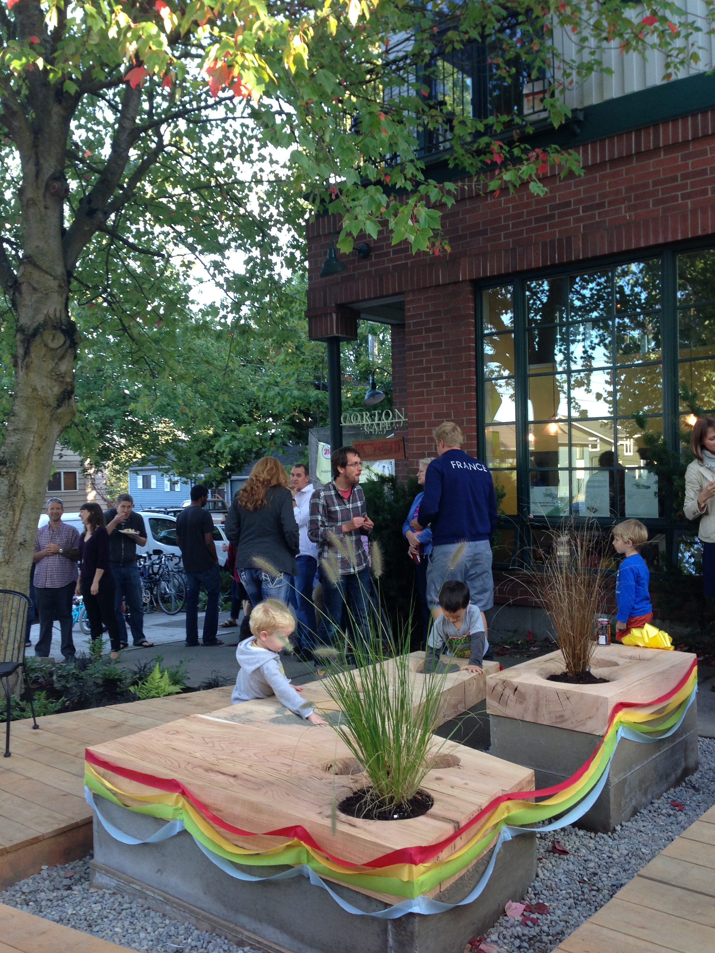 Kids play on top of a parklet in Seattle