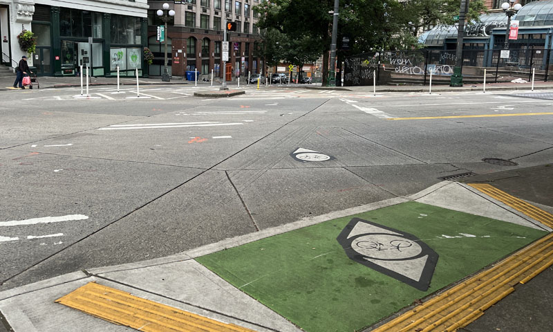 A before shot of the intersection showing an unclear arrow system and no specific bike path