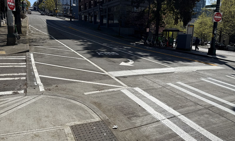 The posts that once separated traffic on the shoulder of Yesler Way are now striped lines on the street