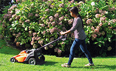 Woman mowing a lawn.