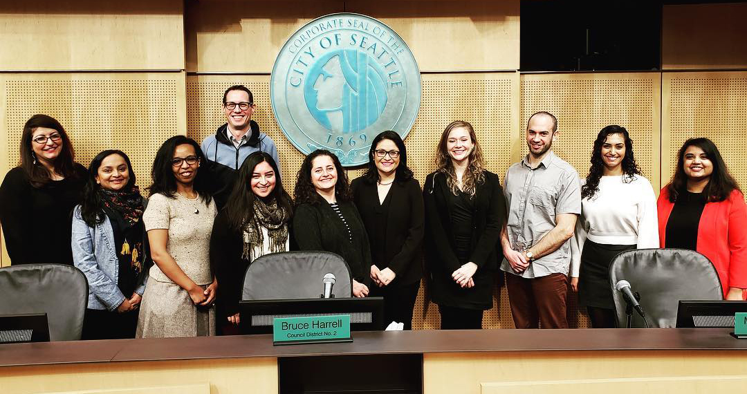 A group photo of some of the Immigrant and Refugee Commission members in Council Chambers.