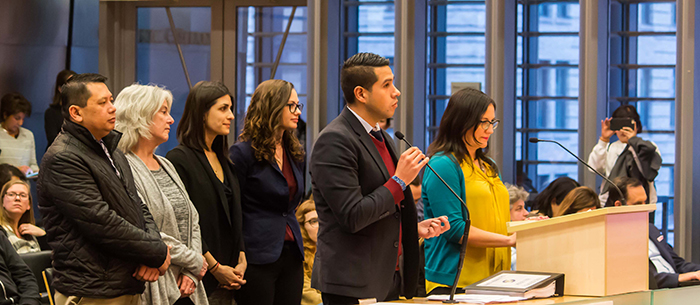 A group of five Immigrant and Refugee Commission members testifying to City Council in Council chambers in support of the City&rsquo;s proposed 2017 Welcoming Resolution.