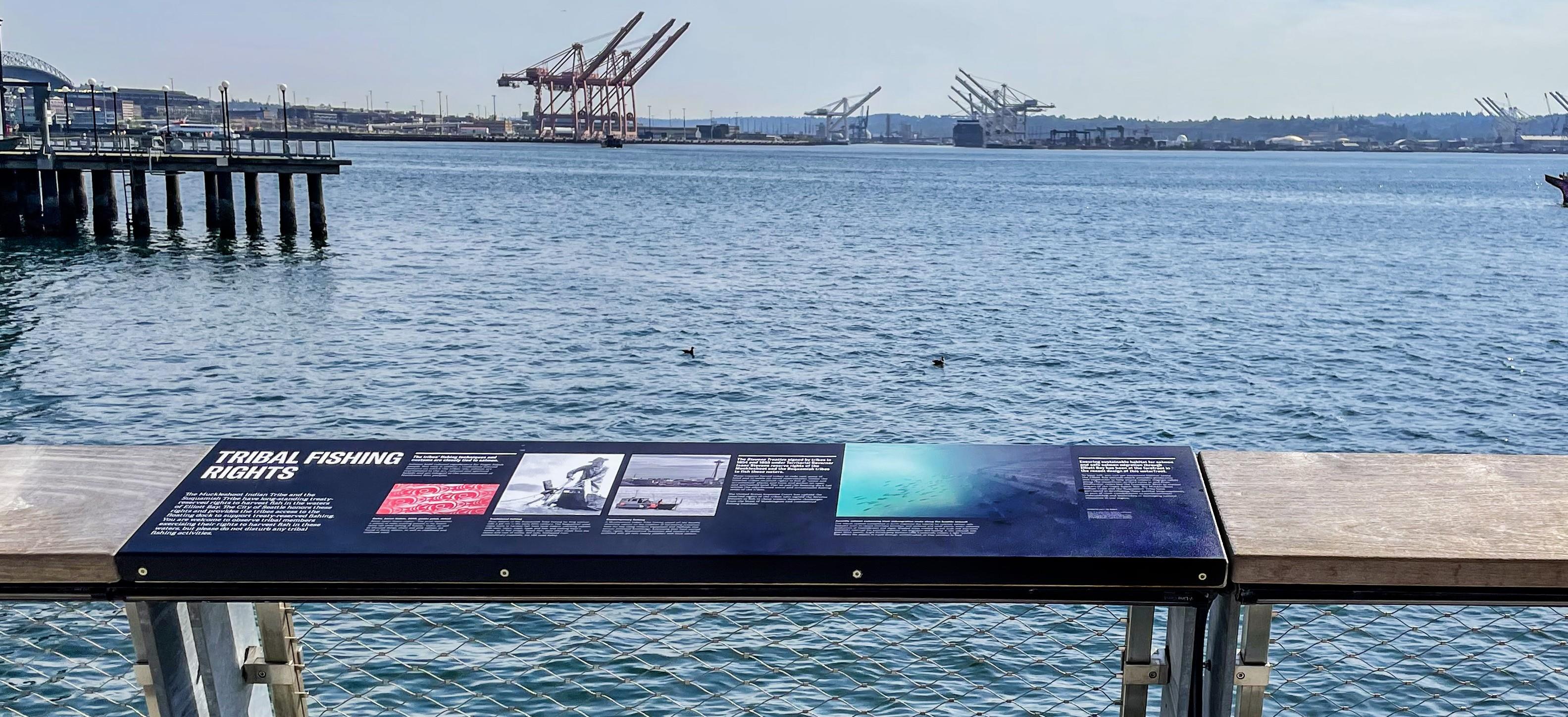 Tribal Fishing Rights interpretive sign with piers, shipping lanes, and Puget Sound in the background