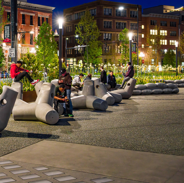 A night shot of people sitting on the Athropomorphic Dolosse and SeaBearer units.