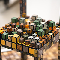 A chair composed of multiple colorful wooden bricks.