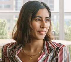 Jahnvi has shoulder length hair and looks off to the left.