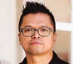 Bennroyce has spike black hair and wears glasses.