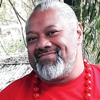 Washington wears large red beads and a red shirt.