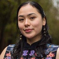 Katharina has long black hair with two braids on each side