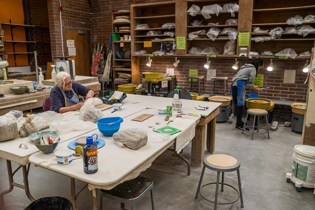 People working with clay in the Pottery Studio