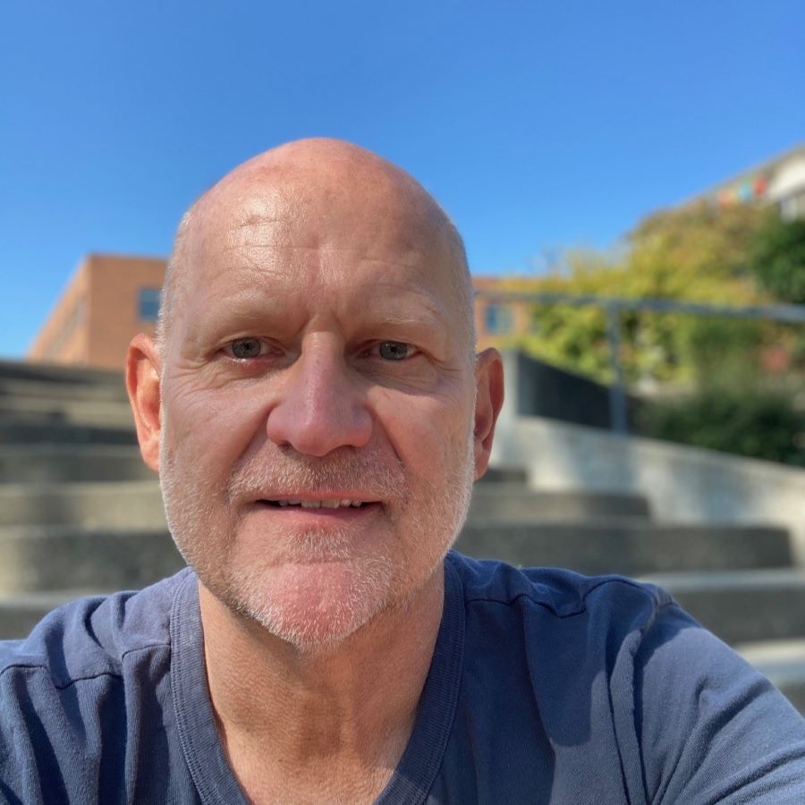A man in front of stairs outside