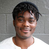 Photo of Matt Howard, leaning against a gray wall 