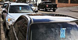 Cars parked with Disabled Parking permits in the window