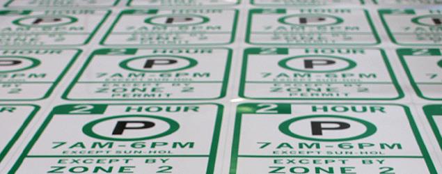 Parking signs being printed in a row by the SDOT sign shop