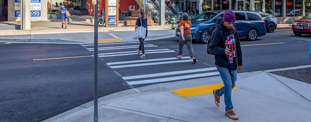 Pedestrians walking on a new crosswalk near the Ballard Blocks