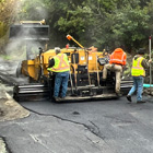 Laying new asphalt road service along Perkins Lane adjacent to the new retaining wall 