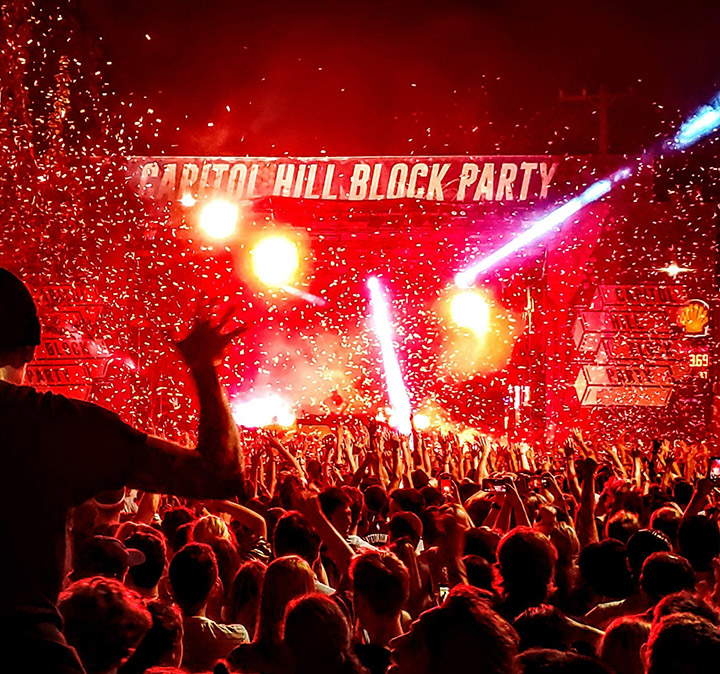 Concertgoers enjoy a live outdoor performance with confetti and lighting effects at Capitol Hill Block Party, 2019.