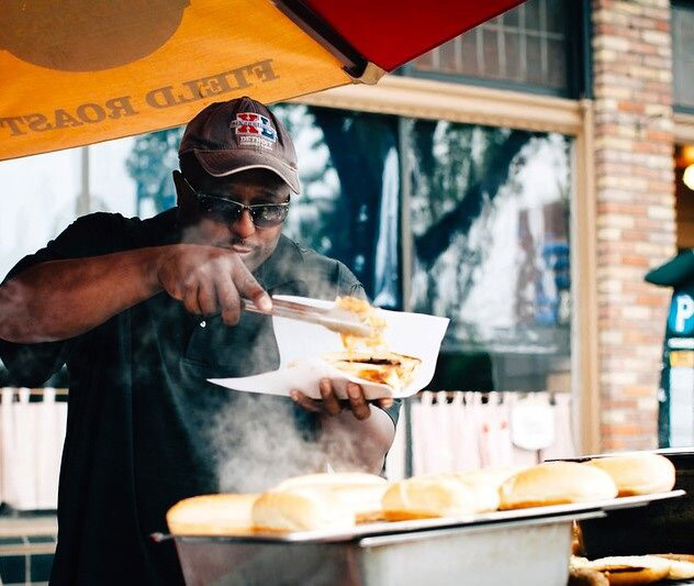 A vendor serves fresh grilled hot dogs at a Ballard Summer Streets event, 2014. Credit: SDOT
