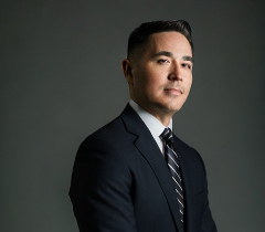 Chief Technology Officer Rob Lloyd smiling in a black and white suit.