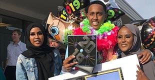 College graduates shown posing after ceremonies