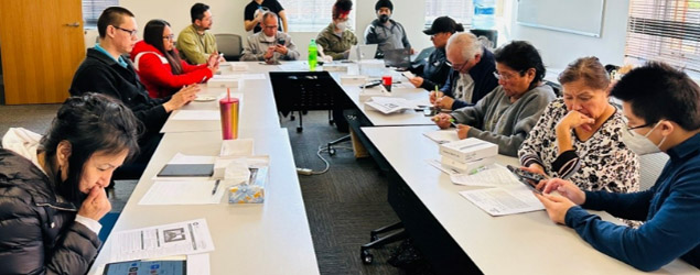 A diverse group of people at work around a table in a conference room