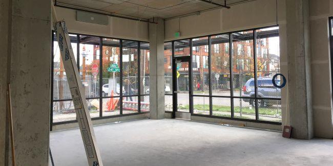 An empty room in a new building with concrete floors and windows