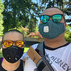 2 volunteers that are wearing masks and sunglasses