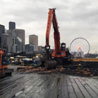 A crane tearing into Pier 63
