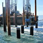 New steel piles being placed in the water. 