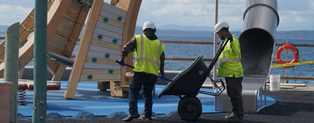 Workers putting finishing touches on the Pier 58 playground